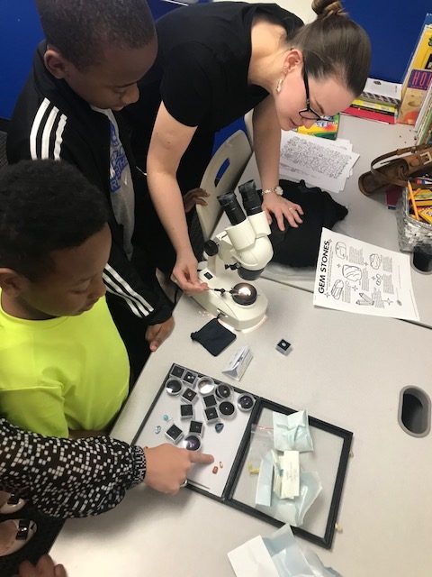 Teaching the kids how to use the microscope to look at gemstones