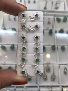 Silver flower studs with deep green emeralds 