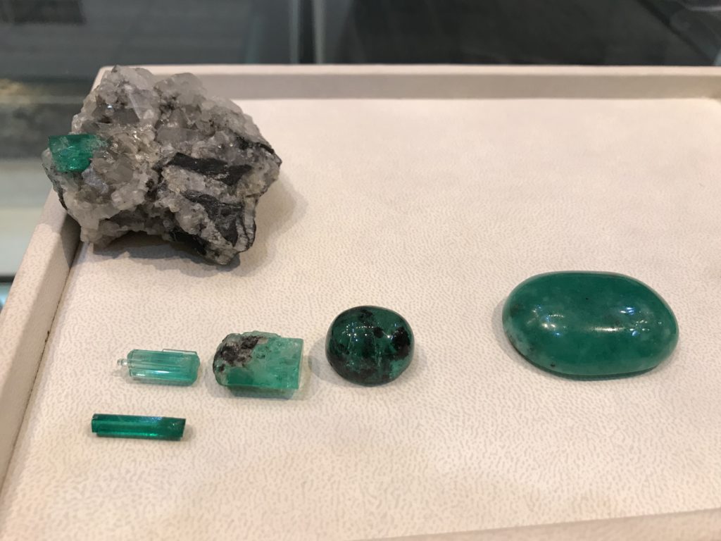 Rough and cabochon emeralds
