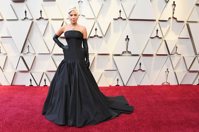 Lady Gaga wears the Tiffany Diamond necklace, earrings and an all-black dress with long black leather gloves